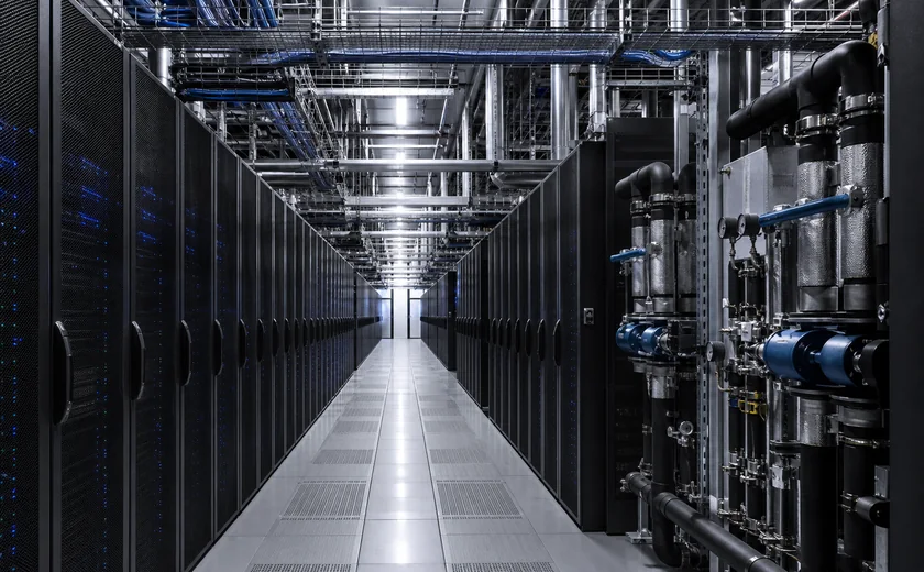 Server aisle and facility cooling pipes inside a data center