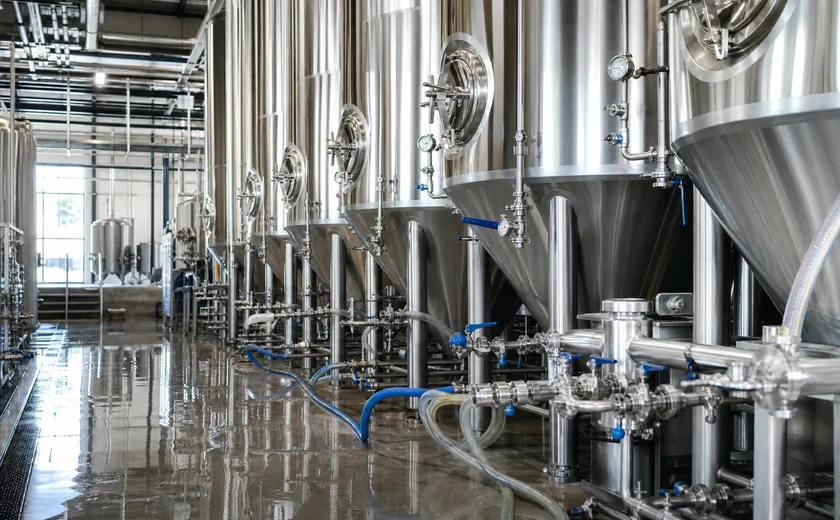 Stainless steel tanks inside a beverage processing facility