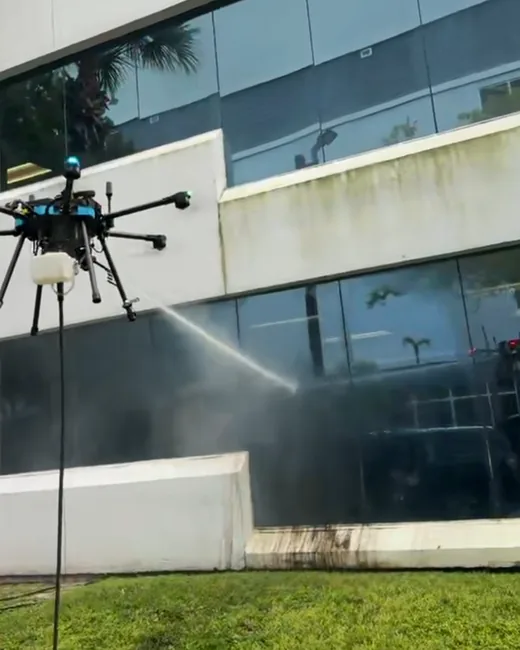 MASEST drone crew washing a commercial building exterior with VertKleen chemistry